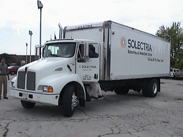 Large white truck in parking lot.